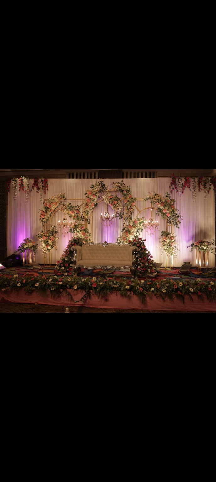 Romantic floral wedding stage with cream sofa